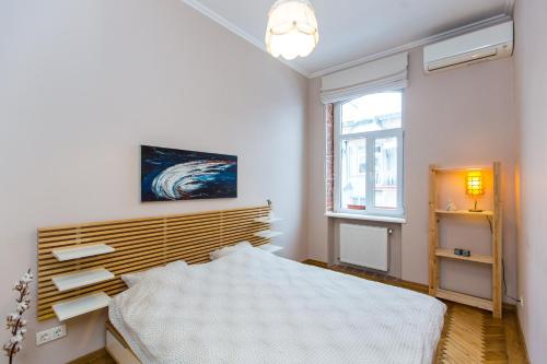 a bedroom with a bed and a window at Light and spacious Apartment on Gazova Str in Lviv