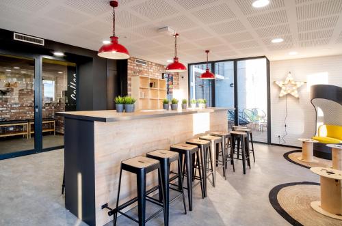 a bar in a restaurant with stools at Student Factory Bordeaux Armagnac in Bordeaux