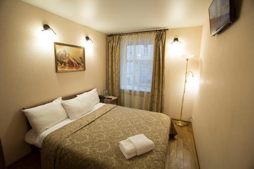 a hotel room with a bed and a window at Prestige Center in Saint Petersburg