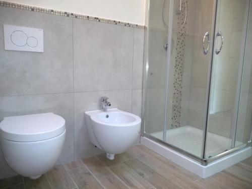 a bathroom with a shower and a toilet and a sink at "Country House il Brolo" in Polpenazze del Garda