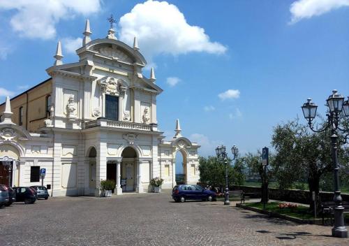 a white building with a car parked in front of it at "Country House il Brolo" in Polpenazze del Garda