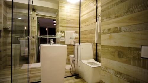 a bathroom with a toilet and a sink at 18 Faces with free drop off to Galle Fort by TukTuk in Galle