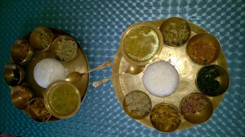 a plate filled with different types of food on a table at Nature Camp Konark Retreat in Konārka