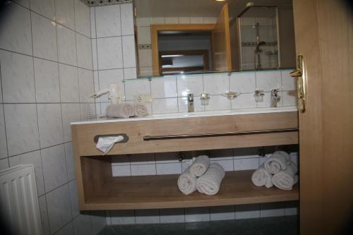 a bathroom with a sink and towels on a shelf at Ritterhof in Fiss