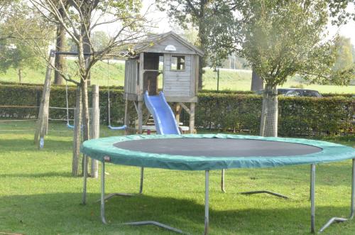 a trampoline in a park with a playground at Guesthouse De Bongerd Overberg, The Orchard in Overberg