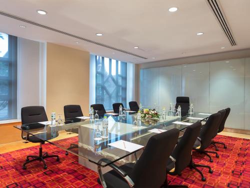 a conference room with a glass table and chairs at The Davis Bangkok in Bangkok