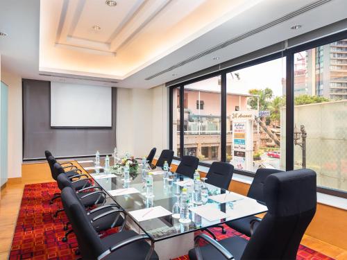 a meeting room with a long table and chairs at The Davis Bangkok in Bangkok