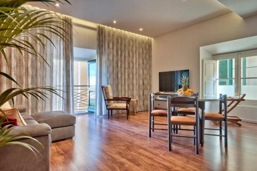 a living room with a table and chairs and a couch at U Collection - a Luxury Collection Suites, Valletta in Valletta