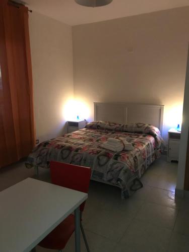 a bedroom with a bed and a table and lights at Villa belvedere in Pontecagnano