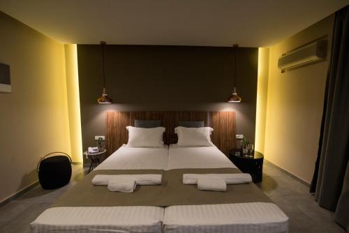 a bedroom with a large bed with two white pillows at Golden Star Relax Hotel - Adults Only 16 plus in Tigaki