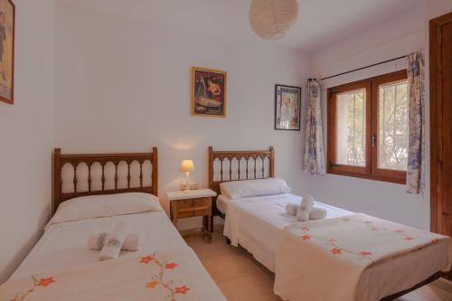 A bed or beds in a room at Villas Guzman - Arcadien