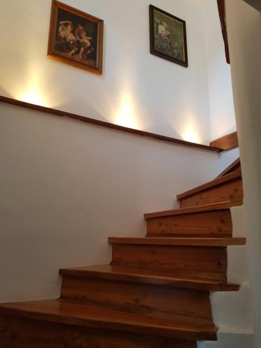 a stairway with two framed pictures on the wall at Apartma Katja in Mojstrana