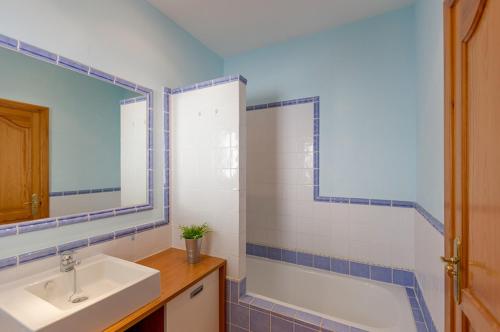 a bathroom with a tub and a sink and a mirror at Villas Guzman - Carlos in Calpe