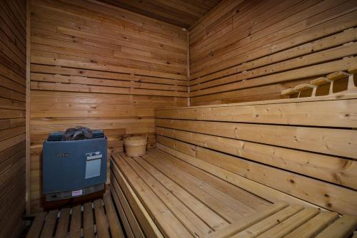 a wooden sauna with a blue cooler in it at Vila House Family in Poprad