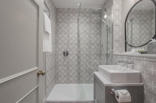 a bathroom with a sink and a shower at Richmond Hill Hotel in Richmond upon Thames