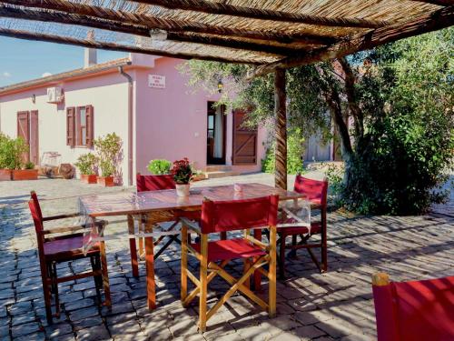 a wooden table and chairs on a patio at Farmhouse Montalto near Sandy Beaches in Montalto di Castro