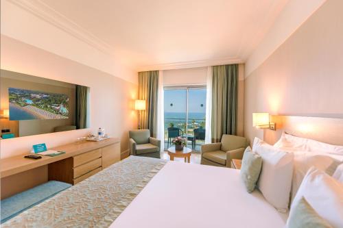 a hotel room with a bed and a desk at Turquoise Hotel in Side
