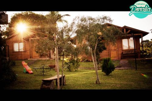 a house with a playground in front of it at Cabañas Doralia in Oberá