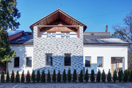 a white house with a brown roof at Valentyna in Lviv