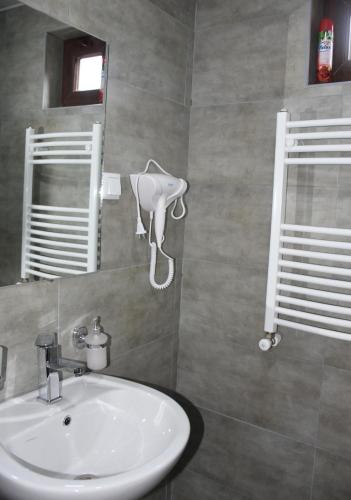 a bathroom with a sink and a mirror at Nikala's house in Borjomi