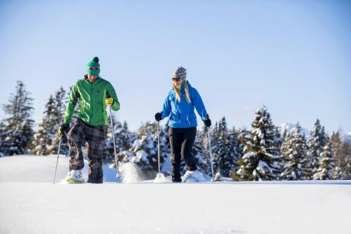 two people are cross country skiing in the snow at Herol - my mountain retreat in Luson