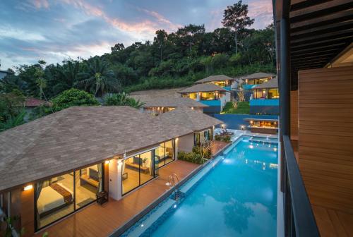 an aerial view of a villa with a swimming pool at Cher​mantra​ Aonang​ Resort & Pool​ Suite in Ao Nang Beach