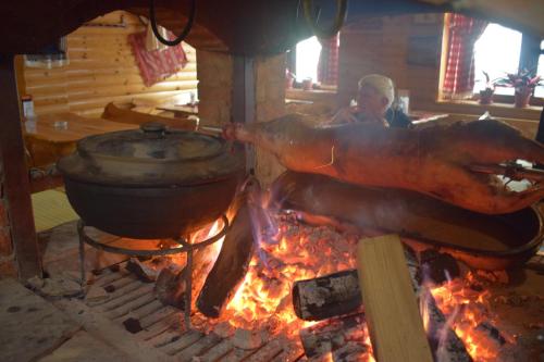 a large turkey being cooked in a pot over a fire at Hotel "Srbija Tis" in Zaječar