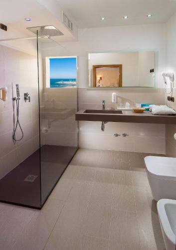 a bathroom with a shower and a sink and a toilet at Park Hotel Cattolica & Restaurant in Cattolica