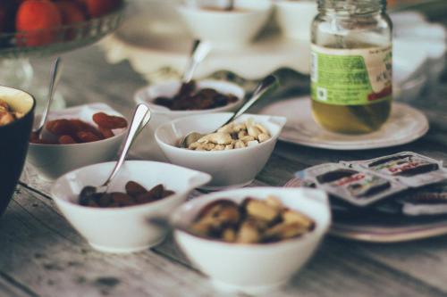 a table topped with bowls of different types of food at B&B La Bouliniere in Malmedy