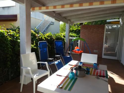 a white table and chairs on a patio at Casammare in Marina di Modica