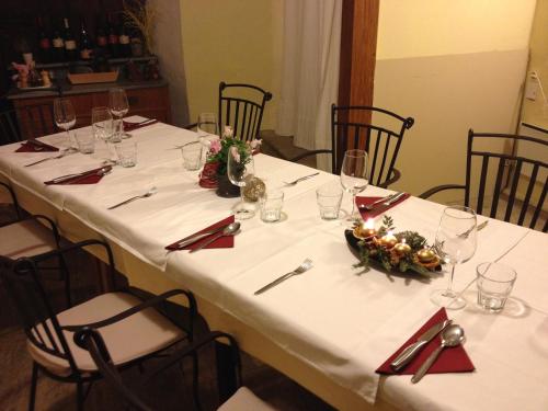 a table with white tablecloths and red napkins at Toncevi Eco Estate in Branik