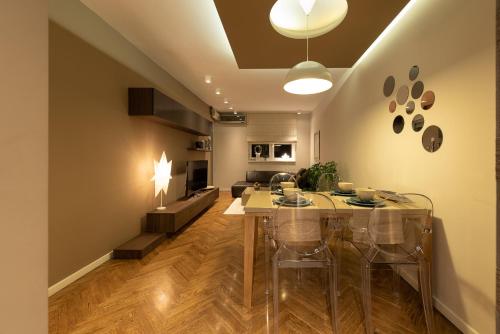 a living room with a dining room table and a kitchen at Apartment NS Life in Novi Sad