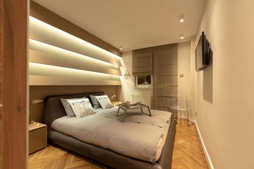 a bedroom with a large bed with a table on it at Apartment NS Life in Novi Sad