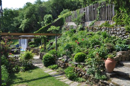 a garden with a stone wall and some plants at Toncevi Eco Estate in Branik