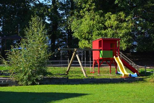 a playground with a slide in a park at Ribelhof in Altstätten