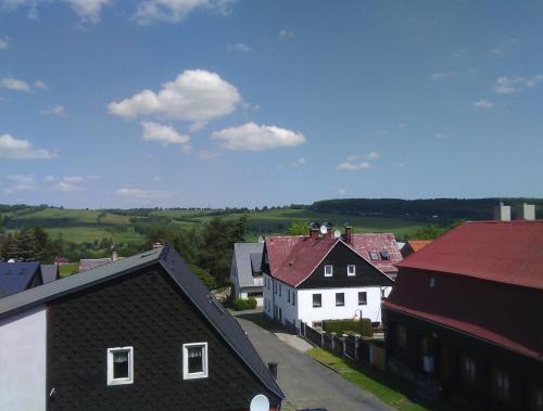 a view of a town with roofs and houses at Jiřetínská chaloupka in Jiřetín pod Jedlovou