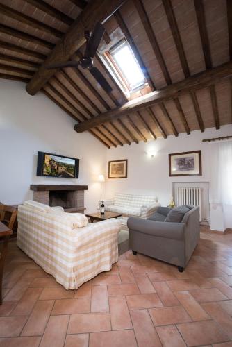 a living room with two couches and a fireplace at Tenuta Decimo - Il Borgo Di Mariano in San Gimignano