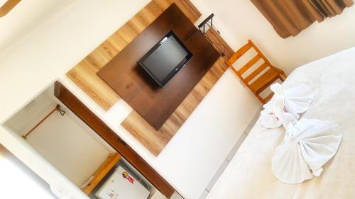 an overhead view of a bedroom with a bed and a television at Chalé Alto da Serra SP in Serra Negra