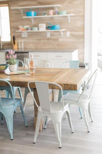 a dining room with a wooden table and chairs at The Shore House in Wildwood