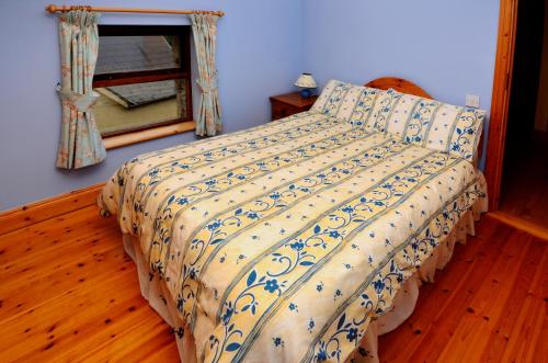 a bedroom with a bed and a window at Cottage 108 - Cleggan in Cleggan