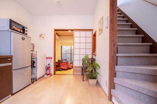 a hallway of a home with stairs and a kitchen at EnSe Higashi Hongan-ji Villa in Kyoto