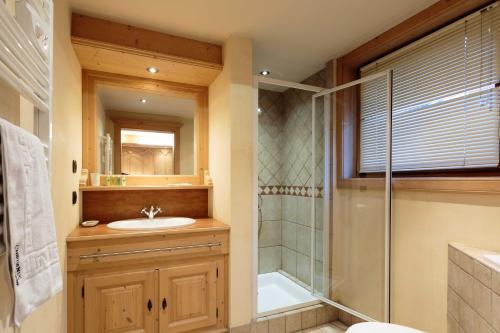 a bathroom with a shower and a sink and a glass shower at Chamois Apartment- Chamonix All Year in Chamonix