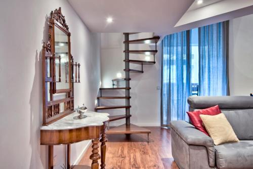 a living room with a staircase and a couch at U Collection - a Luxury Collection Suites, Valletta in Valletta
