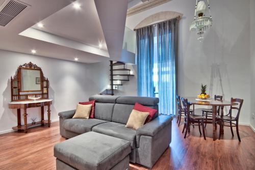a living room with a couch and a table at U Collection - a Luxury Collection Suites, Valletta in Valletta