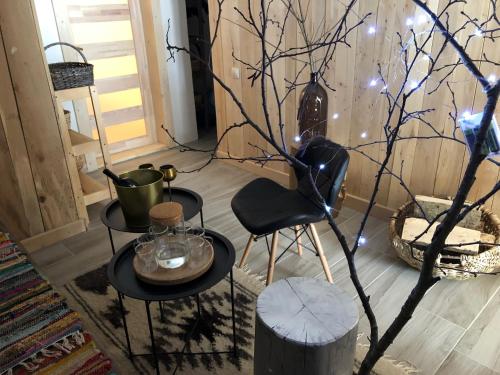 a room with two tables and a tree with lights at ГУЦУЛЬСЬКА ХАТА in Yasinya