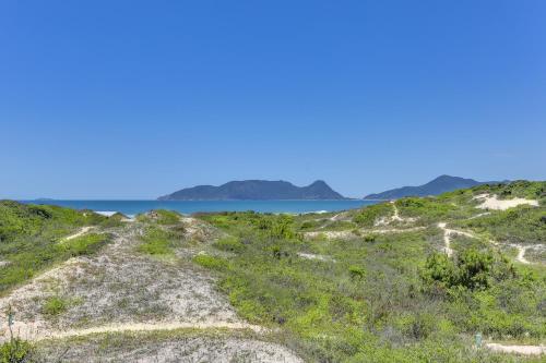 a view of the ocean from the top of a hill at Pousada Ilha Faceira in Florianópolis