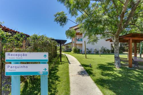 a sign in a park next to a sidewalk at Pousada Ilha Faceira in Florianópolis
