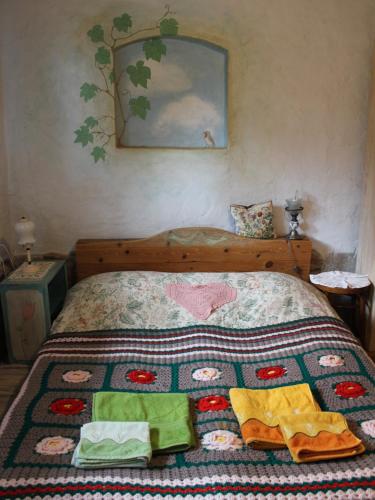 a bedroom with a bed with a quilt on it at Pod tulipanem nad jeziorem in Zawady Oleckie