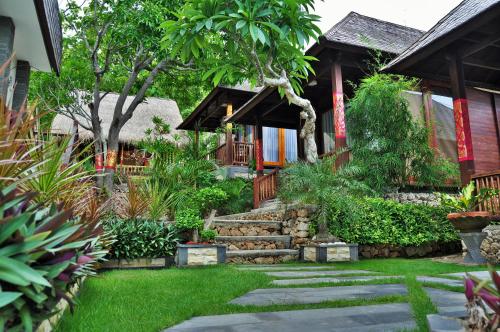 a garden with a path leading to a house at Ocean Terrace Suite And Spa Luxury in Nusa Penida