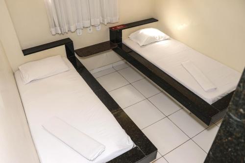 two bunk beds in a room with a tile floor at Hotel Piramide Pernambués (Adults Only) in Salvador